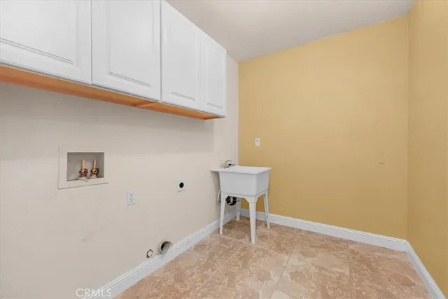 an empty room with wooden floor ceiling fan and windows
