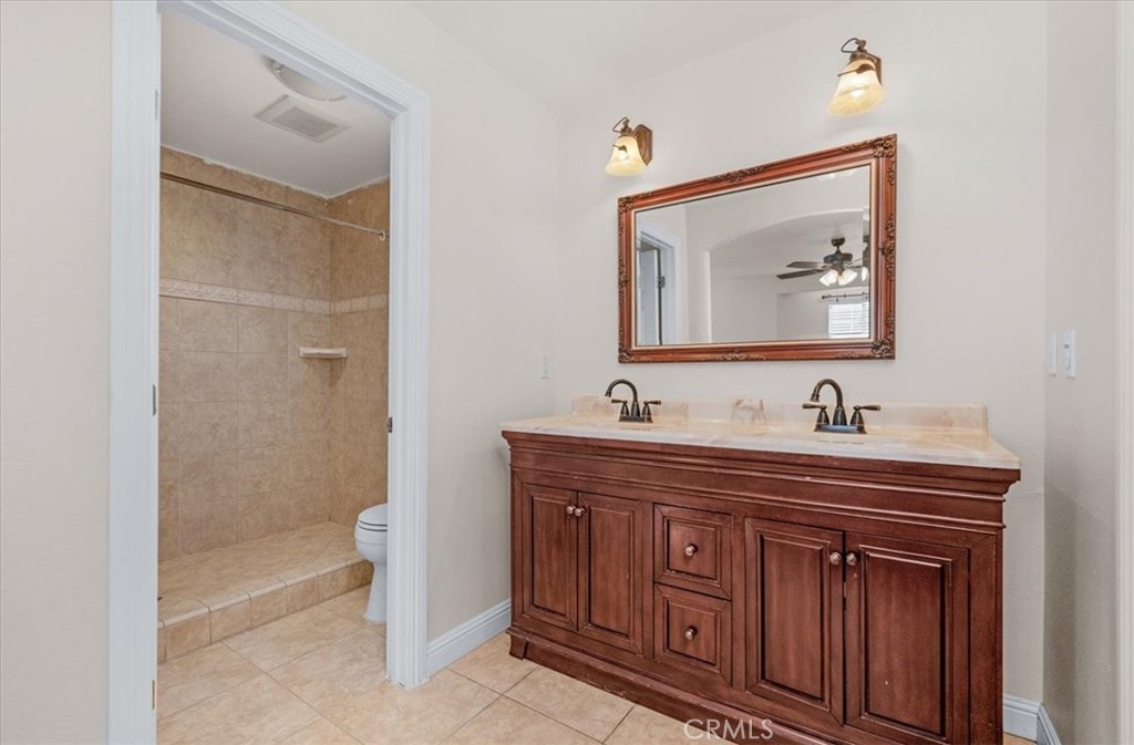 3271 East Muscat Avenue Fresno, CA 93725 - Photo 33 of 53 a bathroom with a sink a mirror and a shower