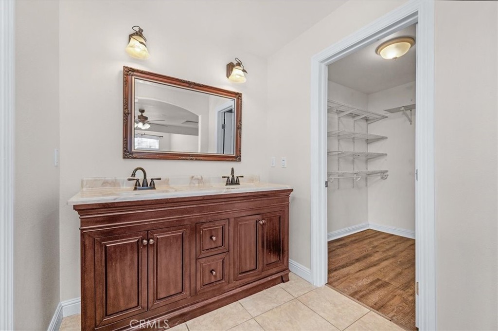 3271 East Muscat Avenue Fresno, CA 93725 - Photo 34 of 53 a bathroom with a sink and a mirror