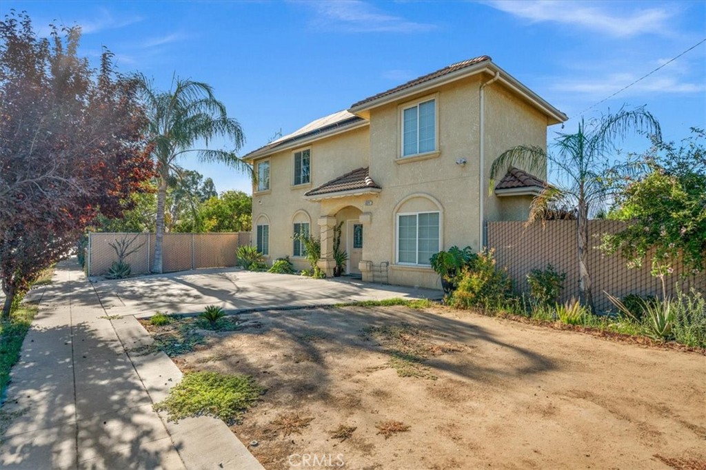 3271 East Muscat Avenue Fresno, CA 93725 - Photo 43 of 53 a view of a white house with a yard and plants