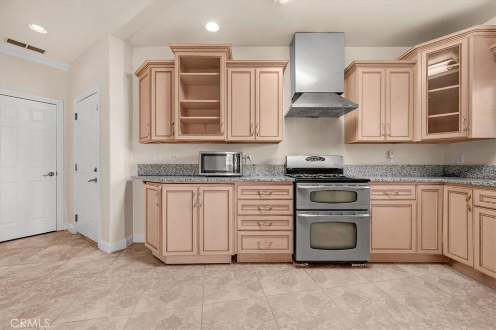 3271 East Muscat Avenue Fresno, CA 93725 - Photo 5 of 53 a kitchen with white cabinets and a stove