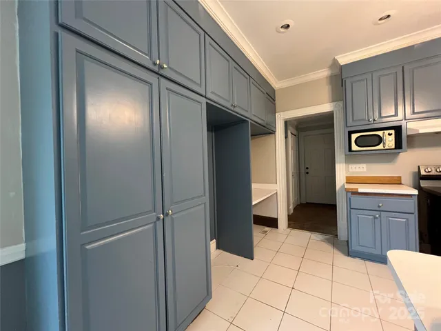 a kitchen with stainless steel appliances a refrigerator and cabinets