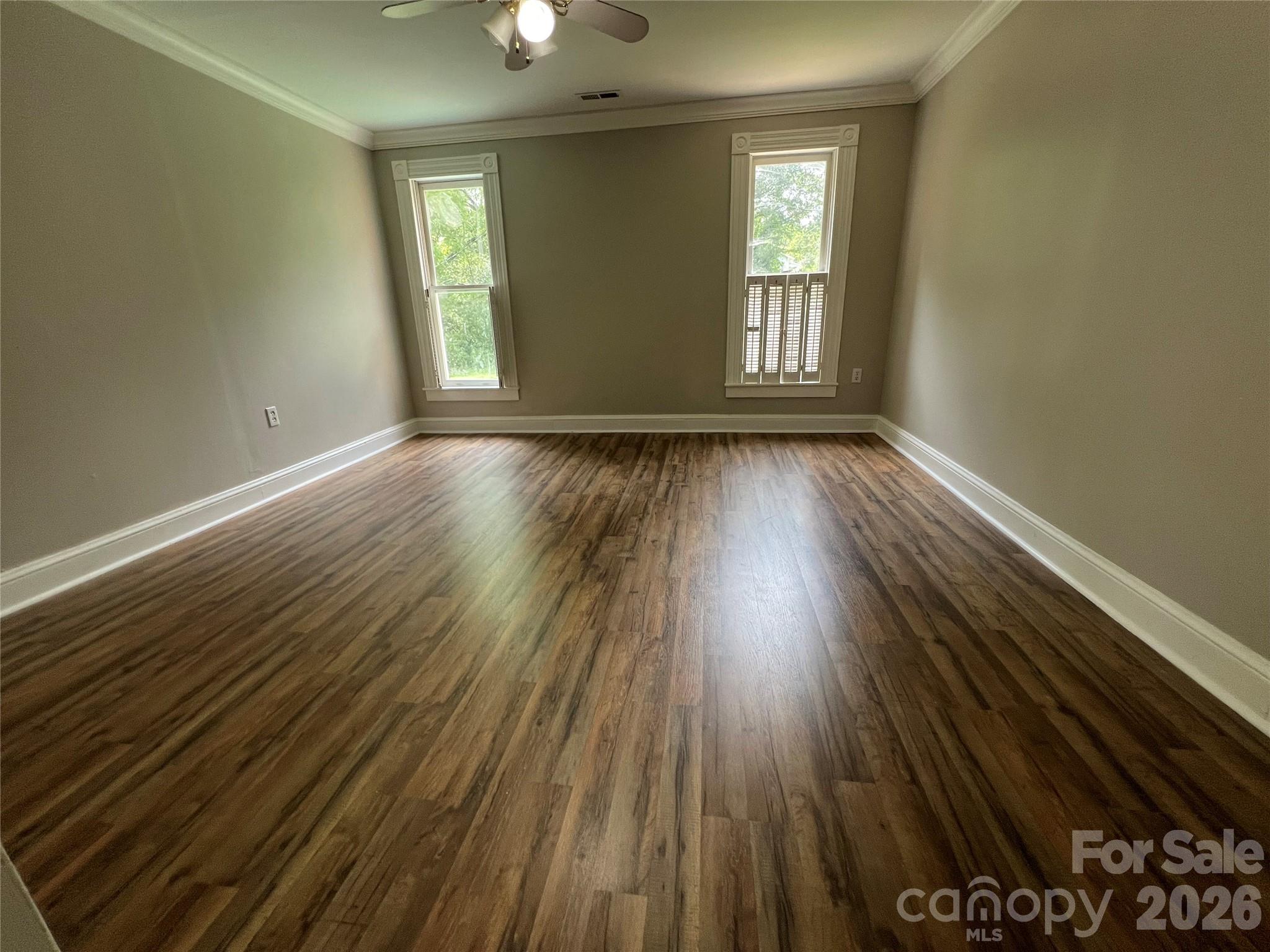 171 North Mitchell Street Rutherfordton, NC 28139 - Photo 22 of 29 a view of an empty room with wooden floor and window