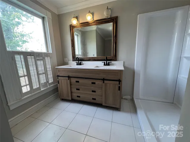 a bathroom with a vanity a mirror and a bathtub