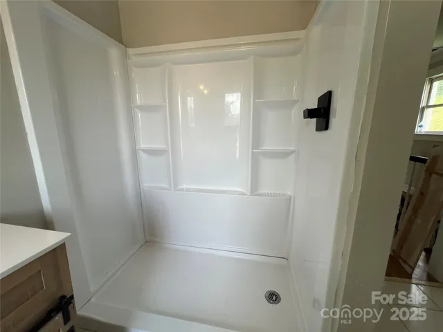 a bathroom with a glass shower door