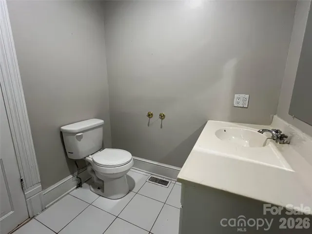 a white toilet sitting next to a bathroom sink
