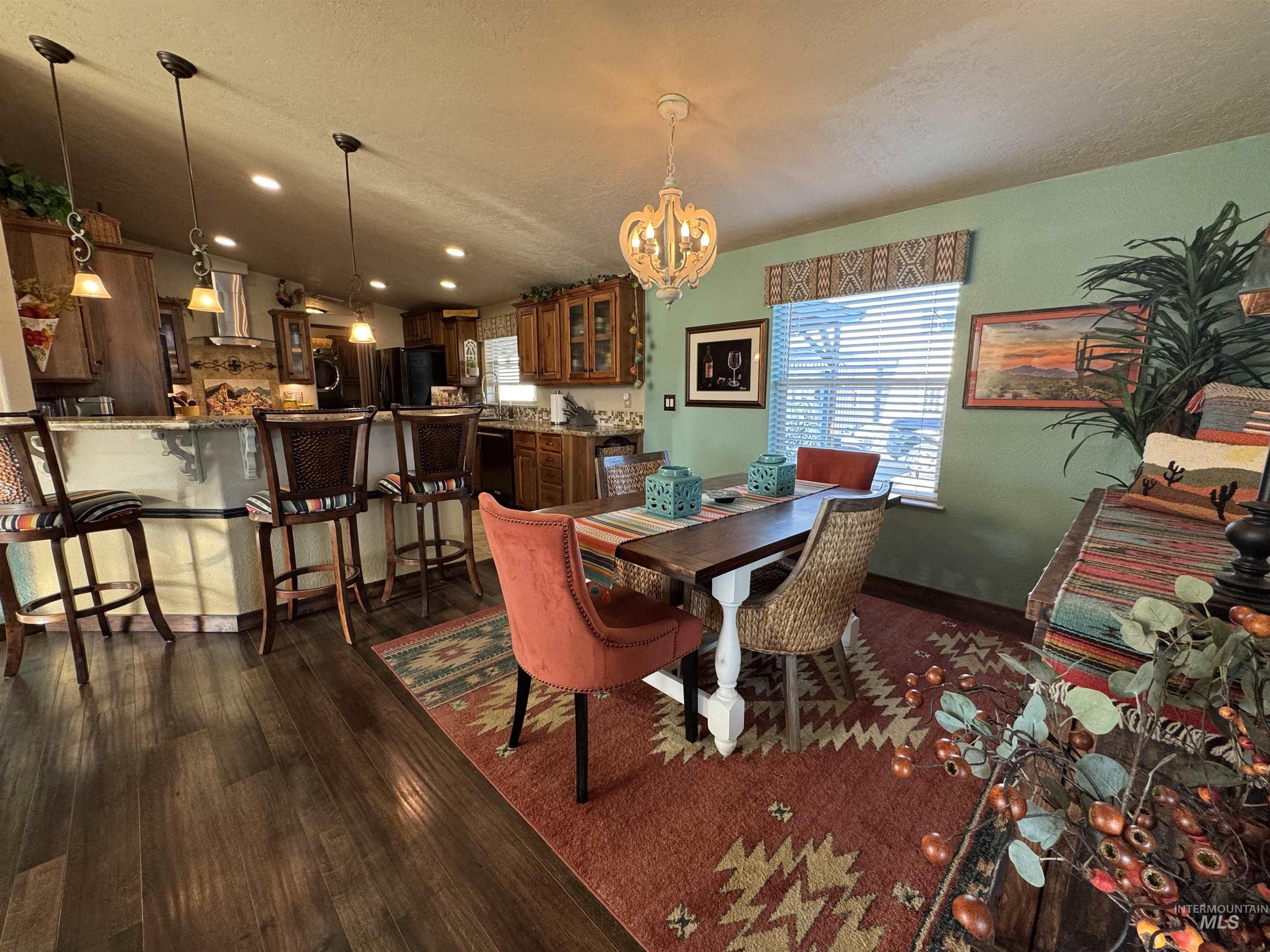 811 14th Street Clarkston, WA 99403 - Photo 13 of 50 Dining room featuring a chandelier, healthy amount of natural light, dark wood-style flooring, recessed lighting, and a textured ceiling