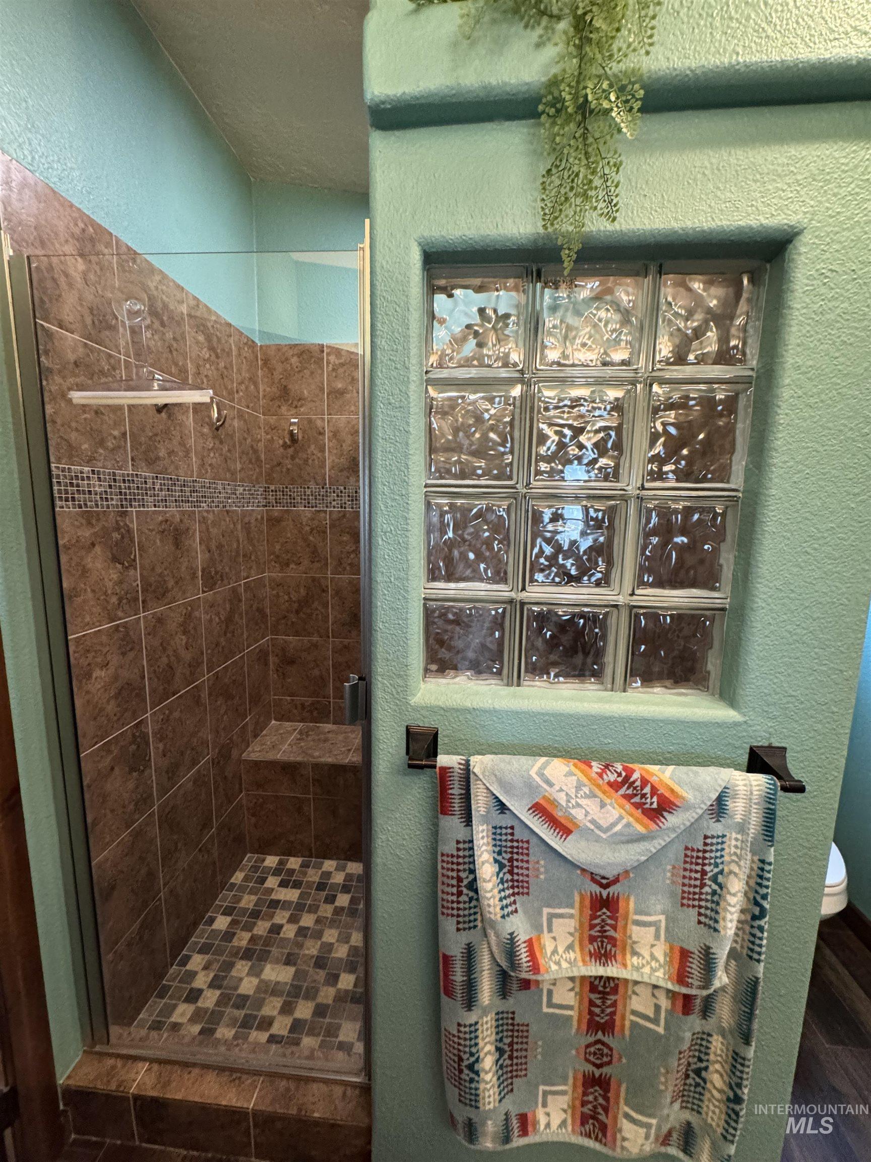 811 14th Street Clarkston, WA 99403 - Photo 26 of 50 Bathroom with a textured wall and a shower stall