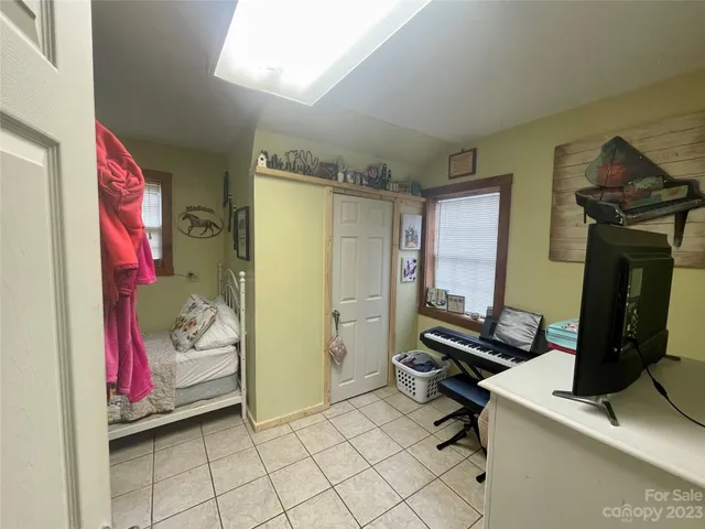 a bedroom with bed and a window