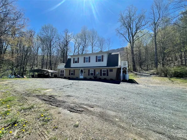 a view of a house with a yard covered in snow