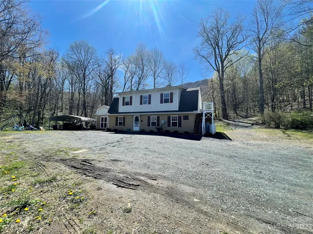 a view of a house with a yard covered in snow