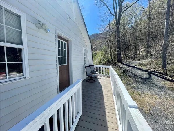a view of a balcony with wooden floor and fence