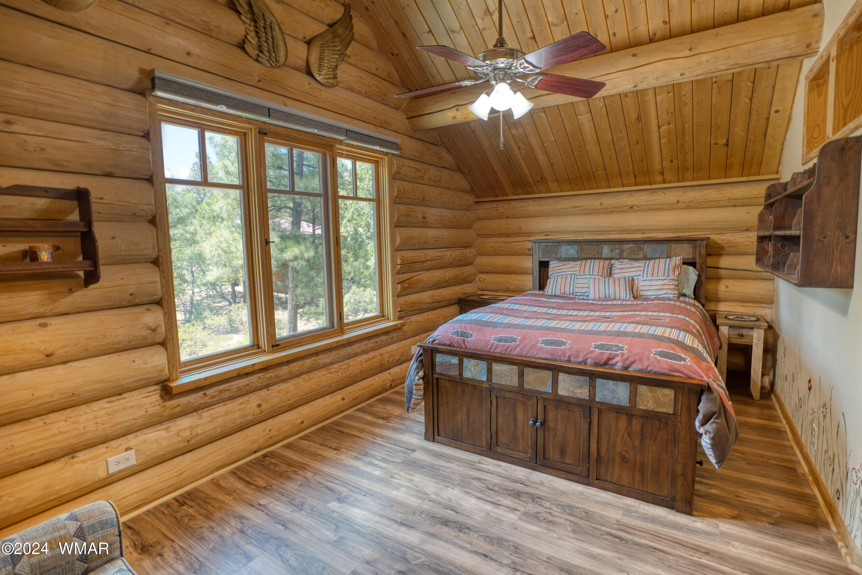 4281 Shaggy Bark Road Show Low, AZ 85901 - Photo 59 of 84 a bedroom with a bed and a large window with wooden floor