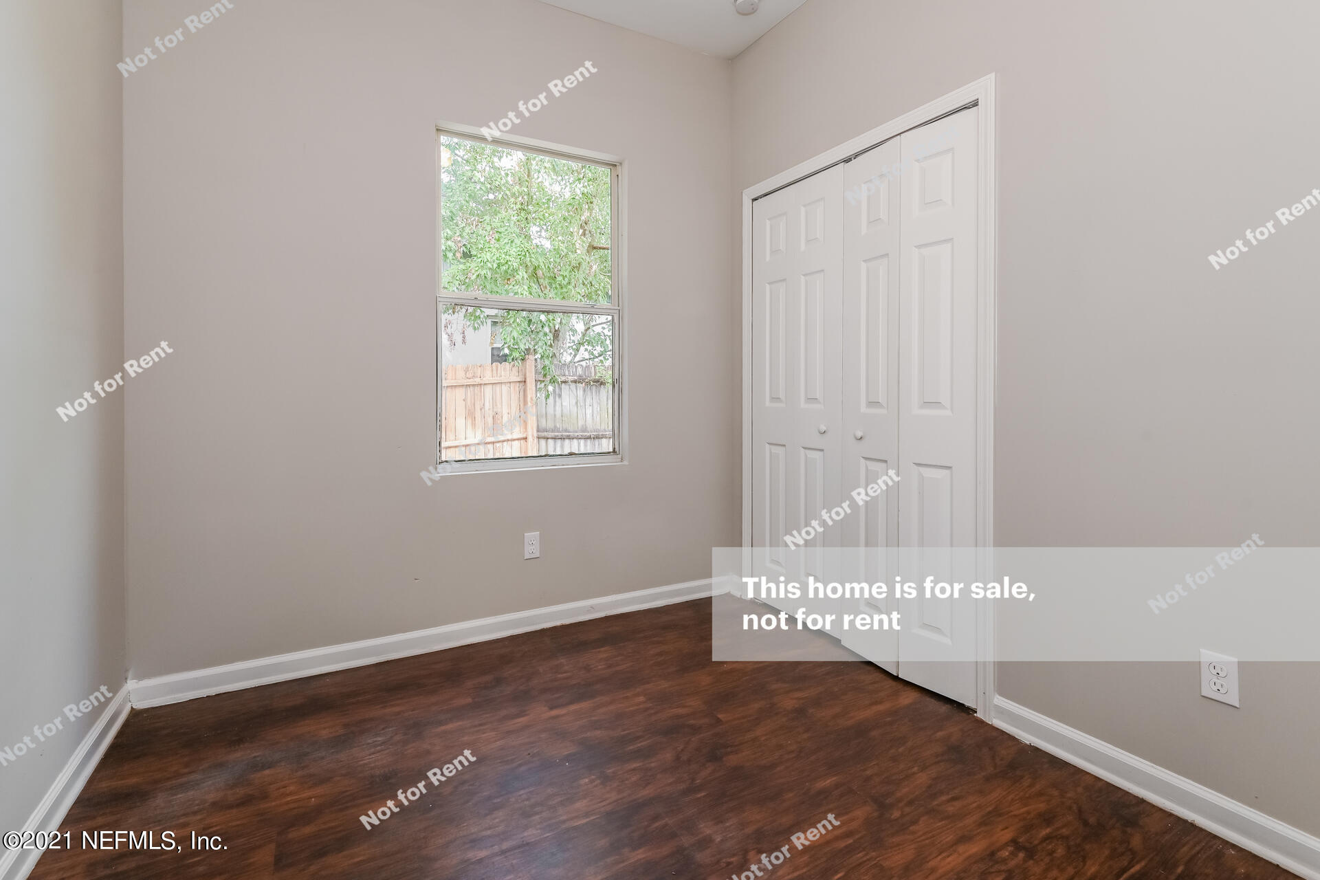 7320 Bamberg Road Jacksonville, FL 32277 - Photo 22 of 27 a view of an empty room with wooden floor and a window