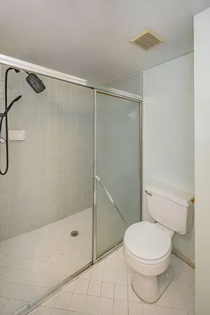 a white toilet and shower