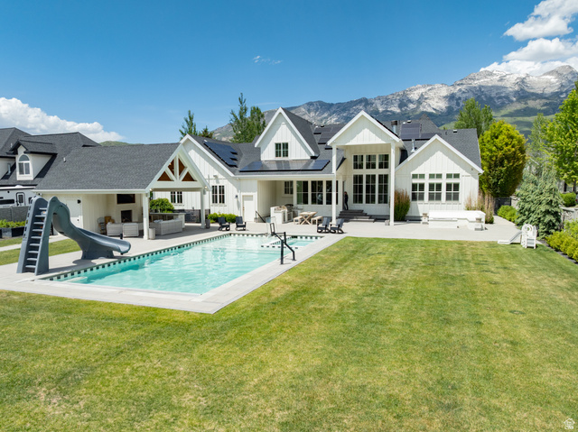 630 East Center Street Alpine, UT 84004 - Photo 100 of 115 Expansive backyard featuring a rectangular swimming pool with integrated slide, a generous lawn area, and a paved patio
