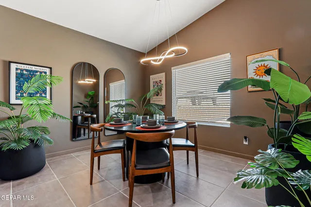 a view of a dining room with furniture and a potted plant