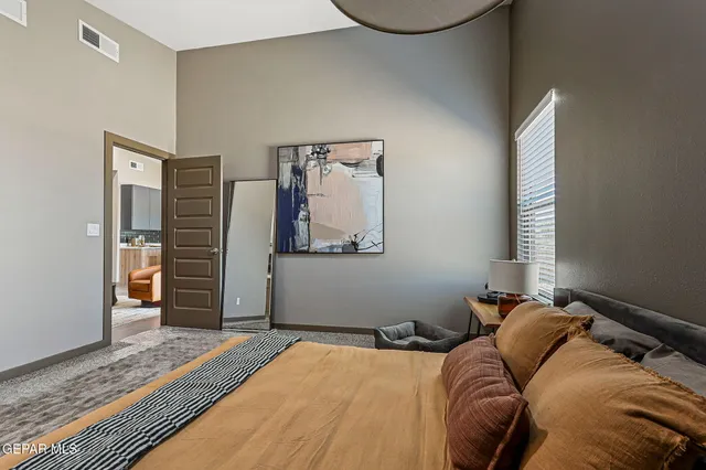 a bed sitting in a bedroom next to a window