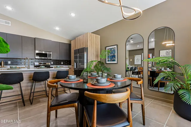 a view of a dining room with furniture and a potted plant