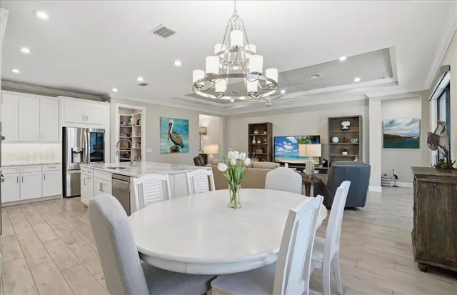 a dining room with furniture and a floor to ceiling window