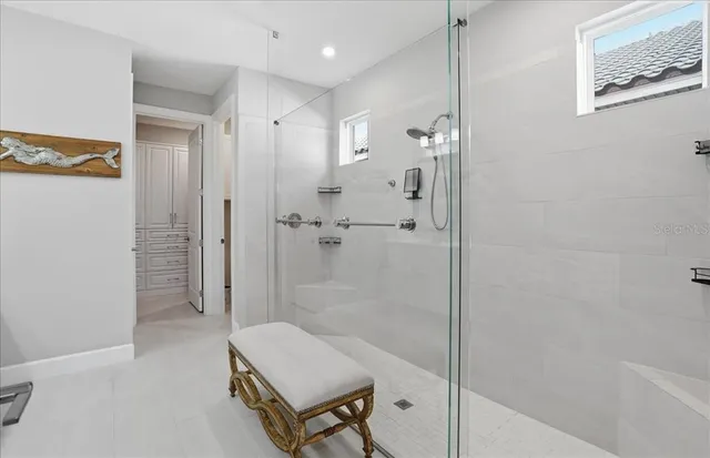 a bedroom with a bed and a lamp on dresser