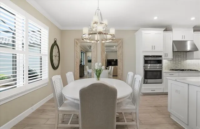 a living room with furniture a flat screen tv and a floor to ceiling window