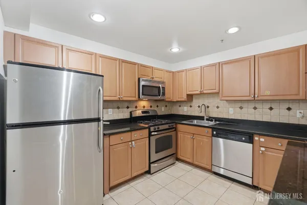 a white refrigerator freezer sitting inside of a kitchen
