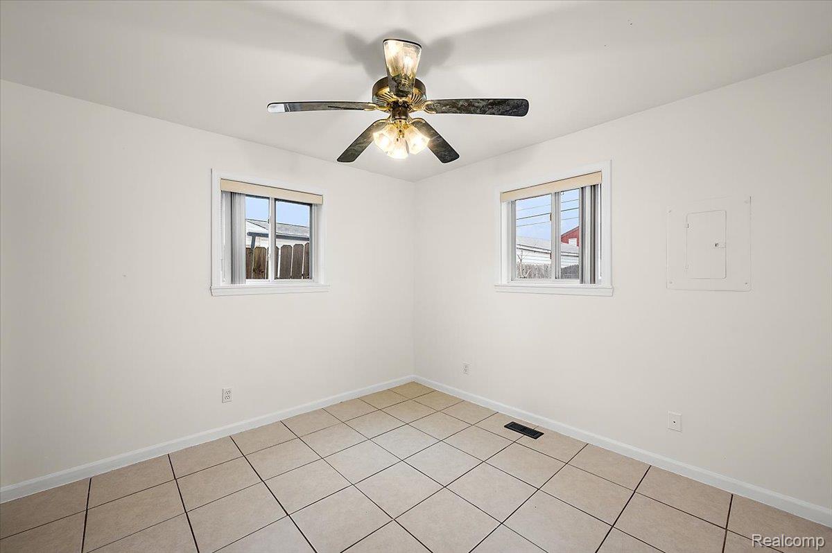 32416 Exeter Drive Warren, MI 48092 - Photo 23 of 33 Empty room featuring healthy amount of natural light, electric panel, and a ceiling fan