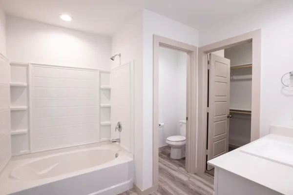 a bathroom with a sink mirror and vanity