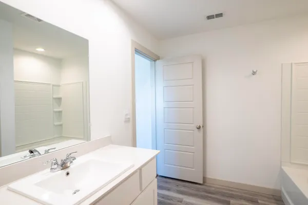 a bathroom with a sink and mirror
