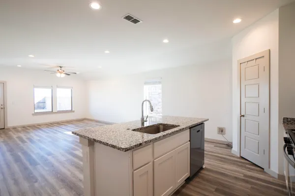 a kitchen with a sink and cabinet