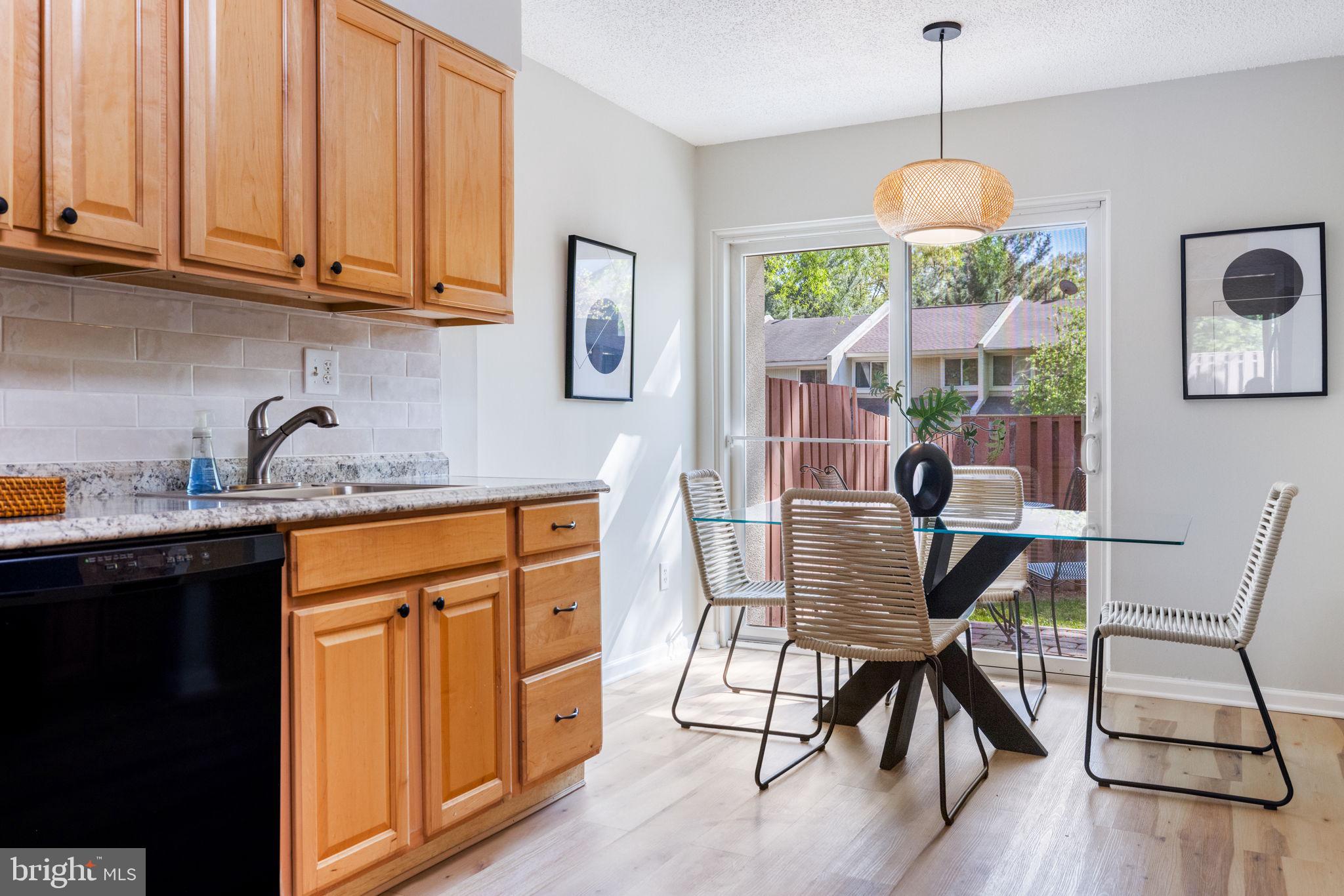 2389 Southgate Square Reston, VA 20191 - Photo 11 of 56 a view of a kitchen area with furniture and wooden floor