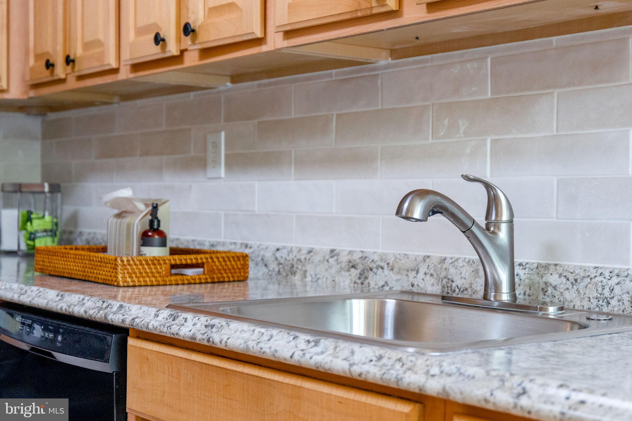 2389 Southgate Square Reston, VA 20191 - Photo 13 of 56 a kitchen with a sink and a counter top space