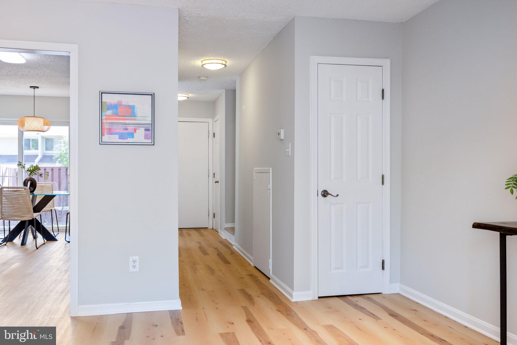 2389 Southgate Square Reston, VA 20191 - Photo 22 of 56 a view of a hallway with wooden floor and dining room