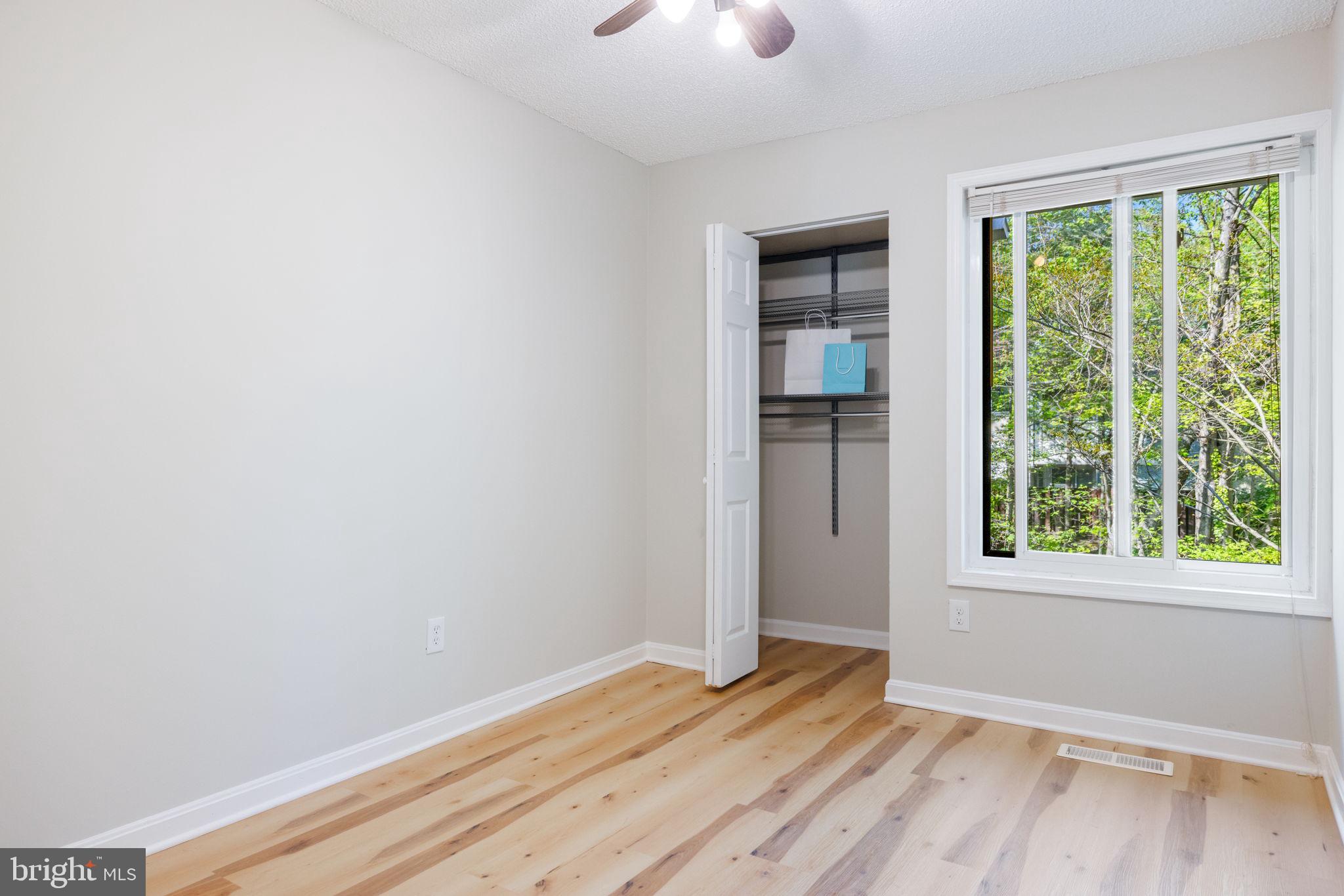 2389 Southgate Square Reston, VA 20191 - Photo 27 of 56 a view of an empty room with wooden floor and a window