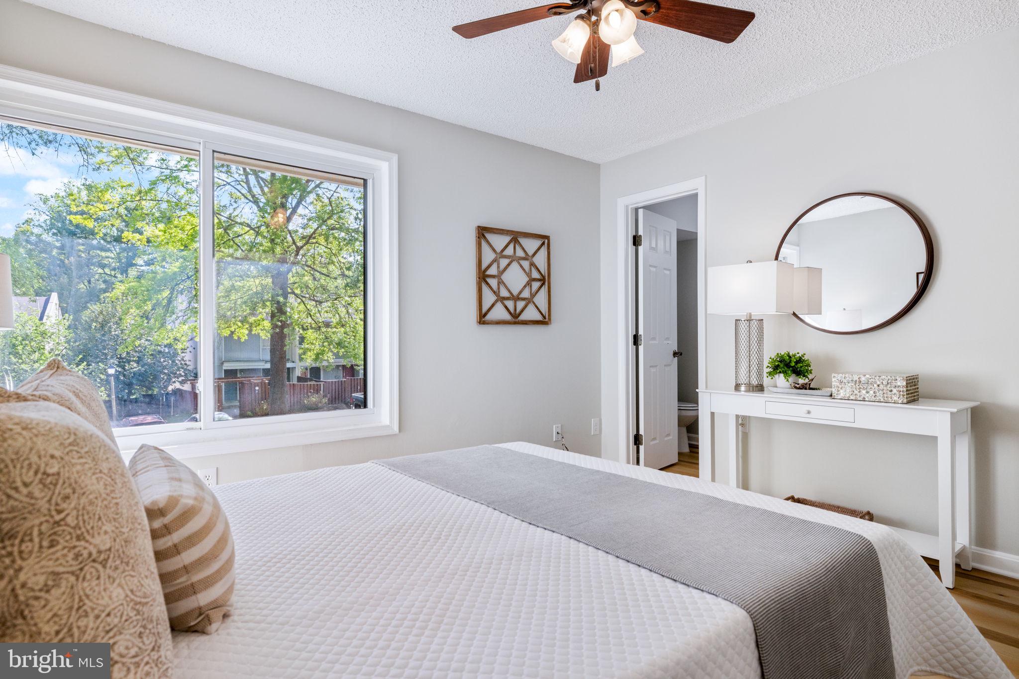 2389 Southgate Square Reston, VA 20191 - Photo 36 of 56 a bedroom with a large bed and a large window