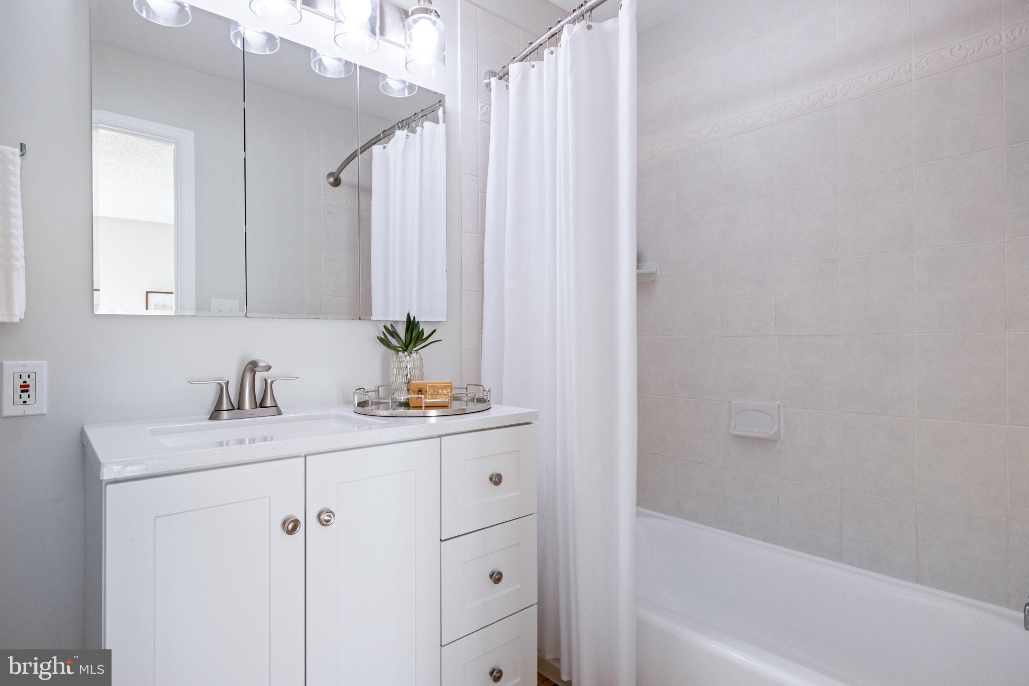 2389 Southgate Square Reston, VA 20191 - Photo 38 of 56 a view of bathroom with bathtub cabinet and mirror