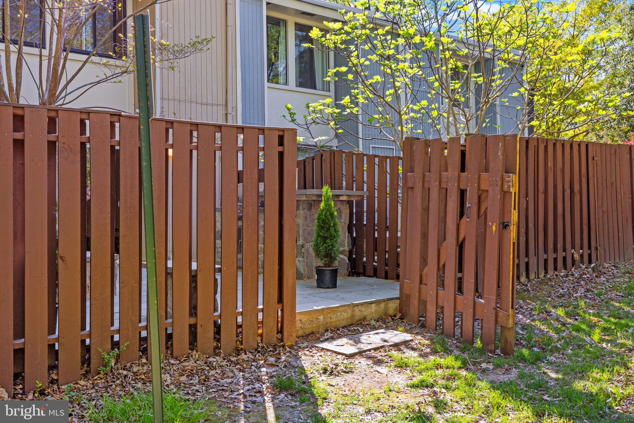 2389 Southgate Square Reston, VA 20191 - Photo 45 of 56 a view of a wooden fence with a small yard