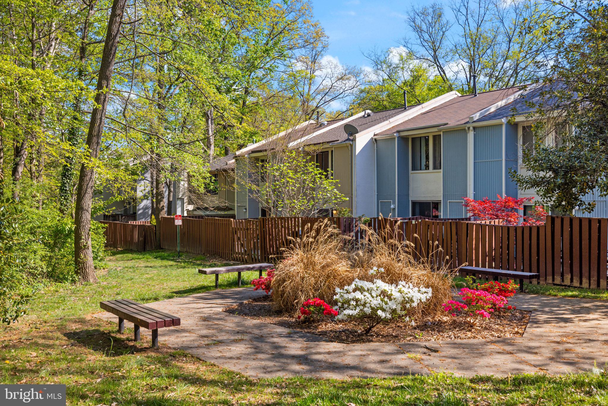 2389 Southgate Square Reston, VA 20191 - Photo 46 of 56 a view of a backyard with plants and a bench in the patio
