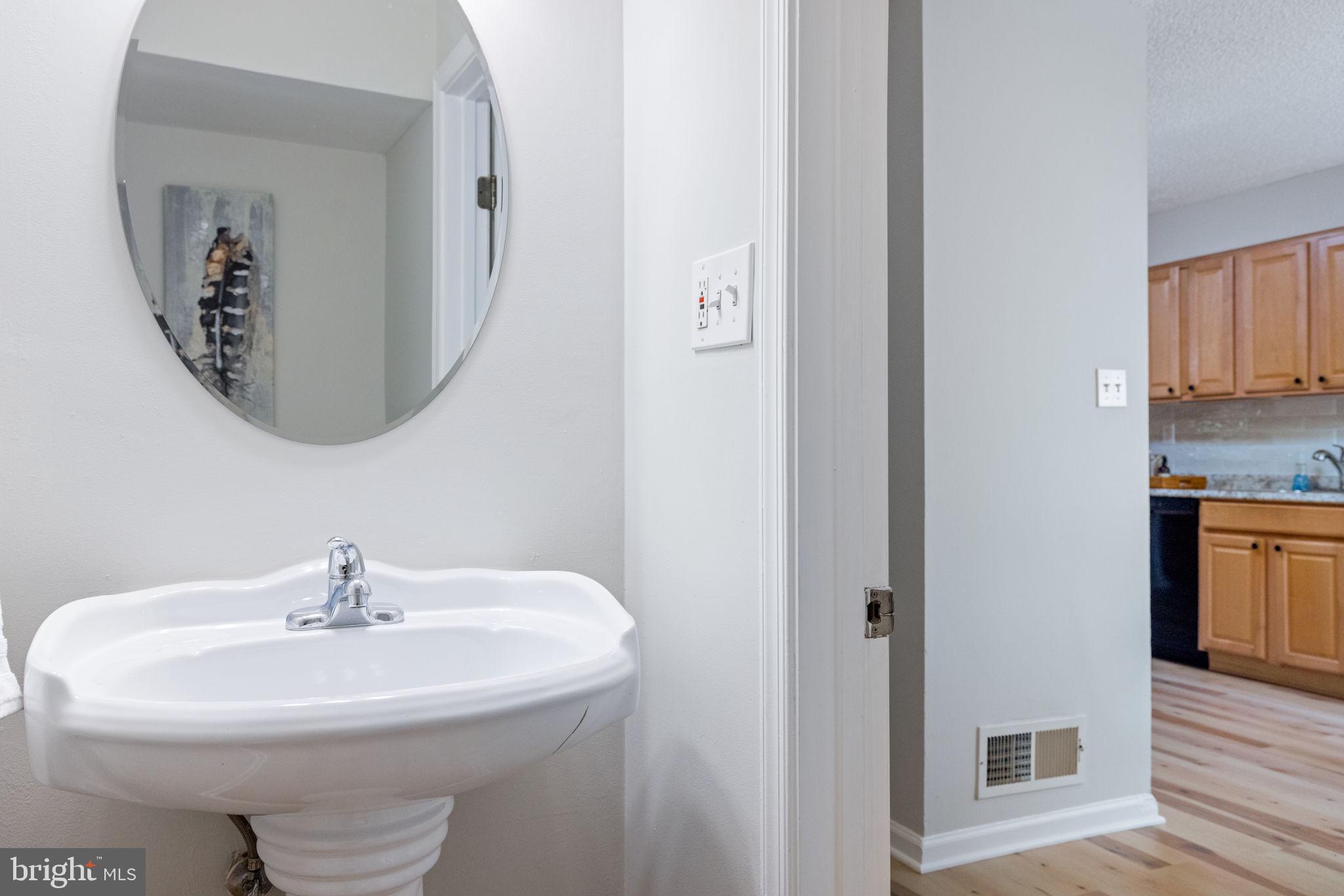 2389 Southgate Square Reston, VA 20191 - Photo 7 of 56 a sink with a mirror and vanity