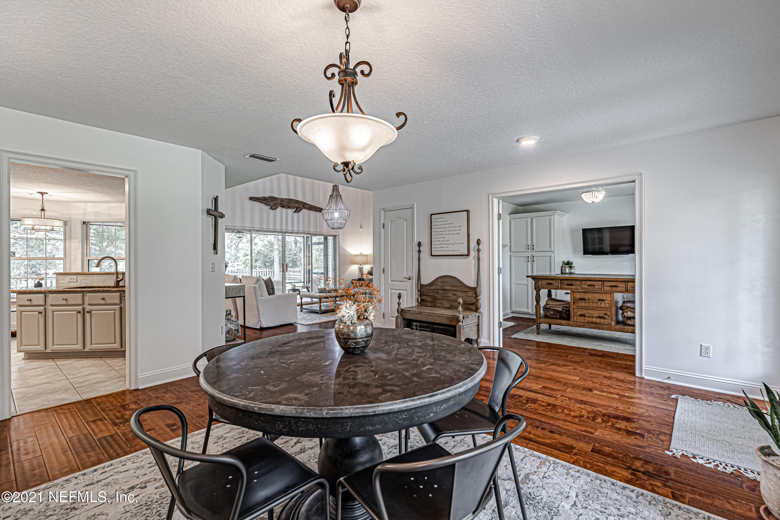 184 Circuit Rider Road Green Cove Springs, FL 32043 - Photo 11 of 58 a view of a dining room with furniture wooden floor and chandelier