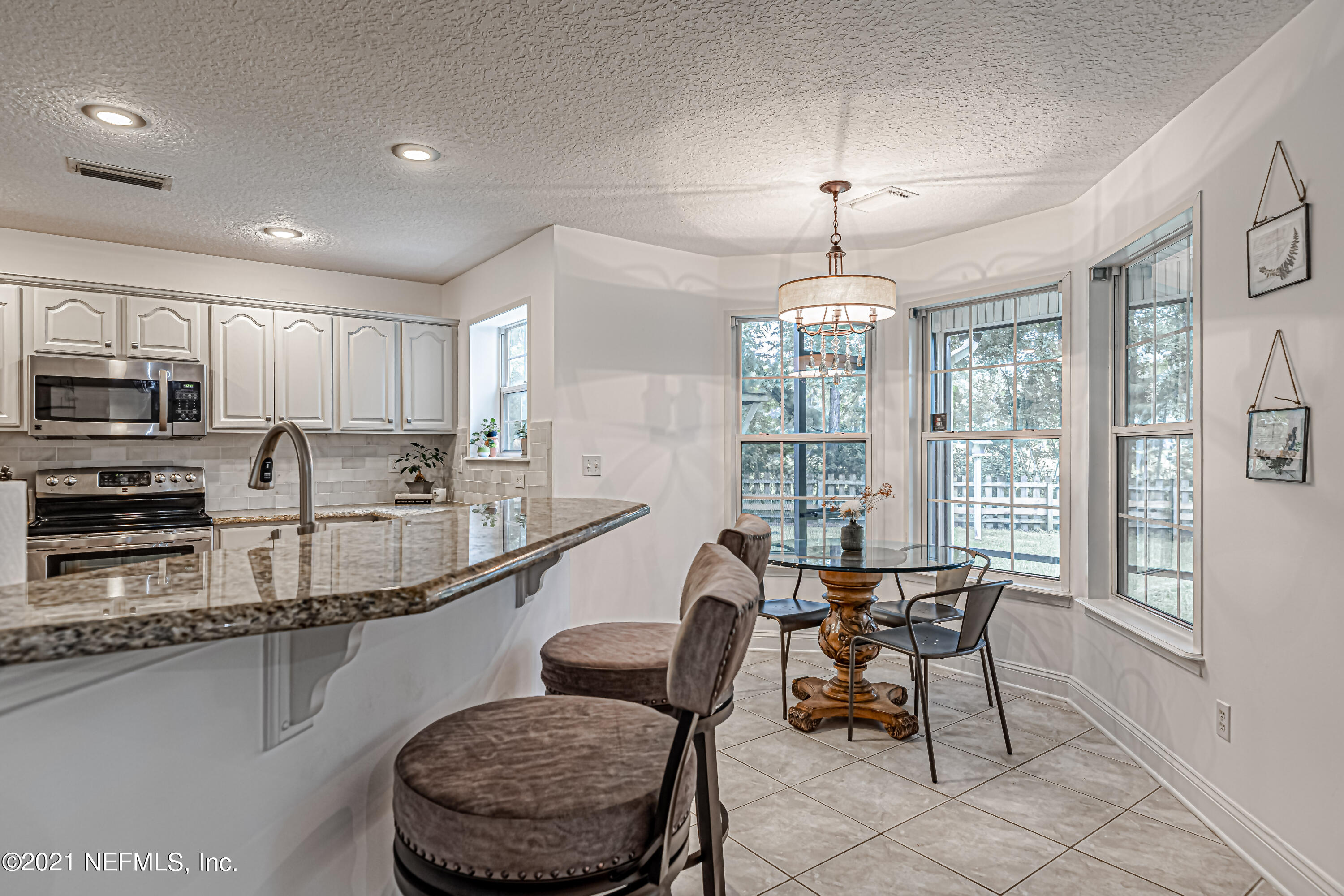 184 Circuit Rider Road Green Cove Springs, FL 32043 - Photo 20 of 58 a kitchen with stainless steel appliances granite countertop a stove a sink and a refrigerator