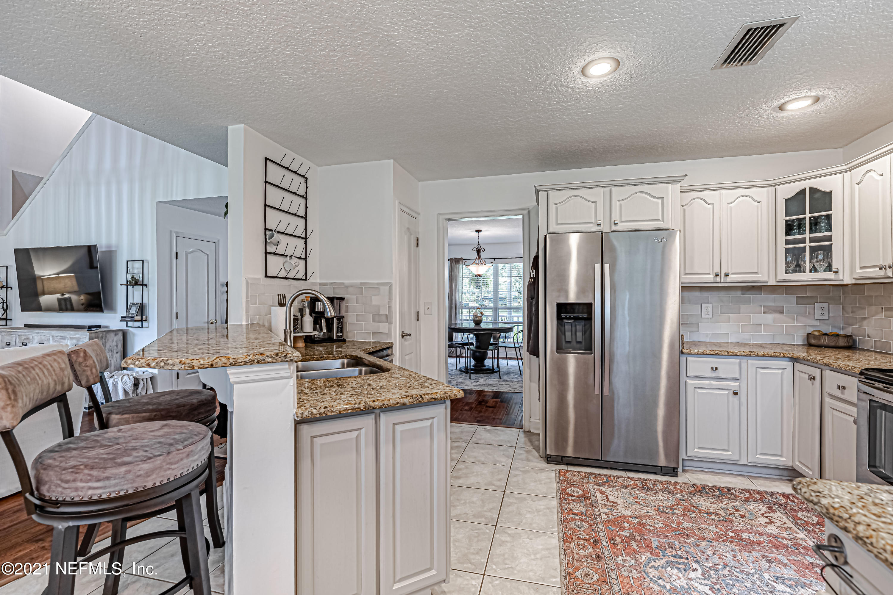 184 Circuit Rider Road Green Cove Springs, FL 32043 - Photo 24 of 58 a living room with stainless steel appliances granite countertop furniture a fireplace a flat screen tv and a window