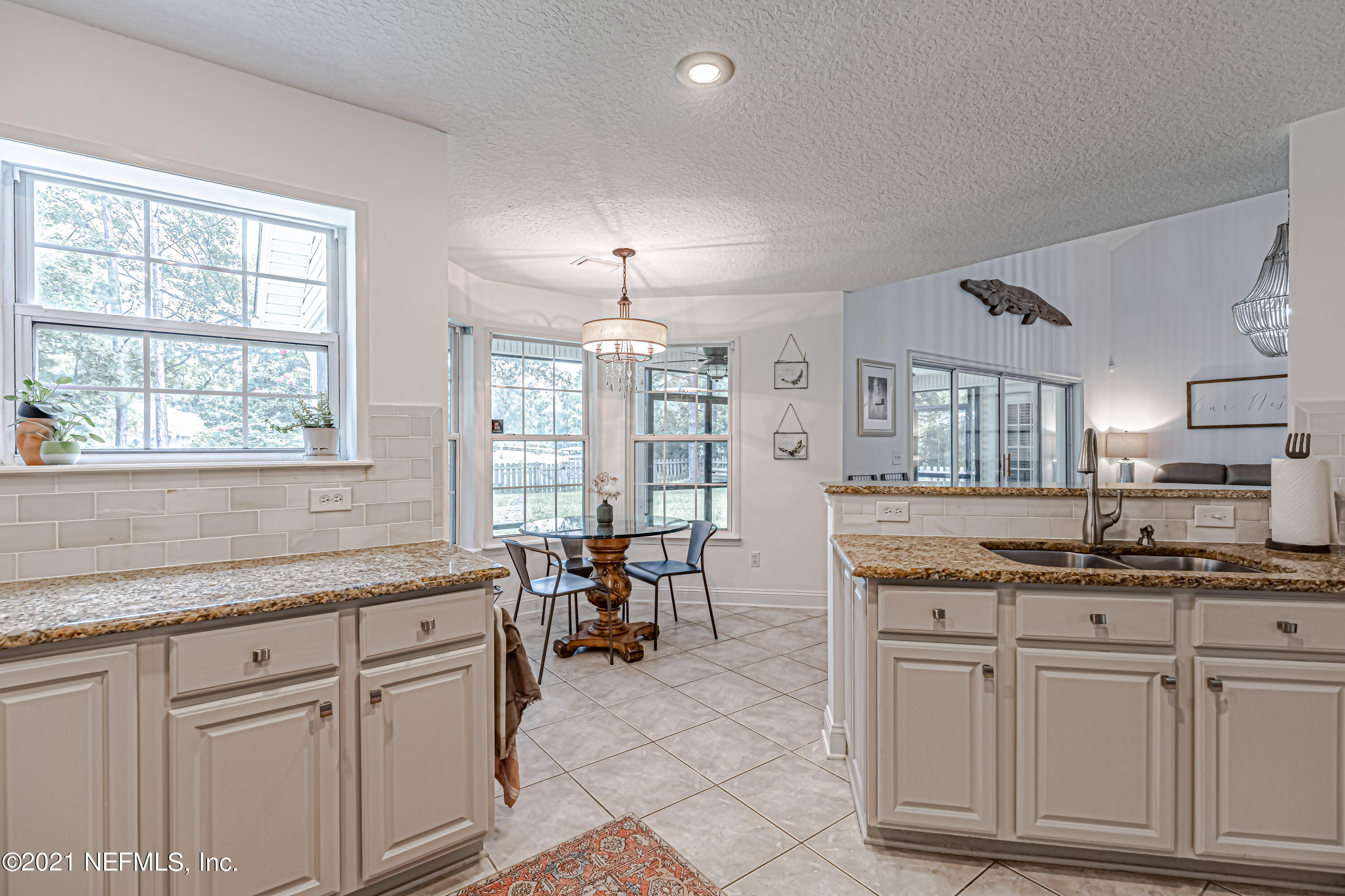 184 Circuit Rider Road Green Cove Springs, FL 32043 - Photo 25 of 58 a kitchen with kitchen island granite countertop a sink and cabinets
