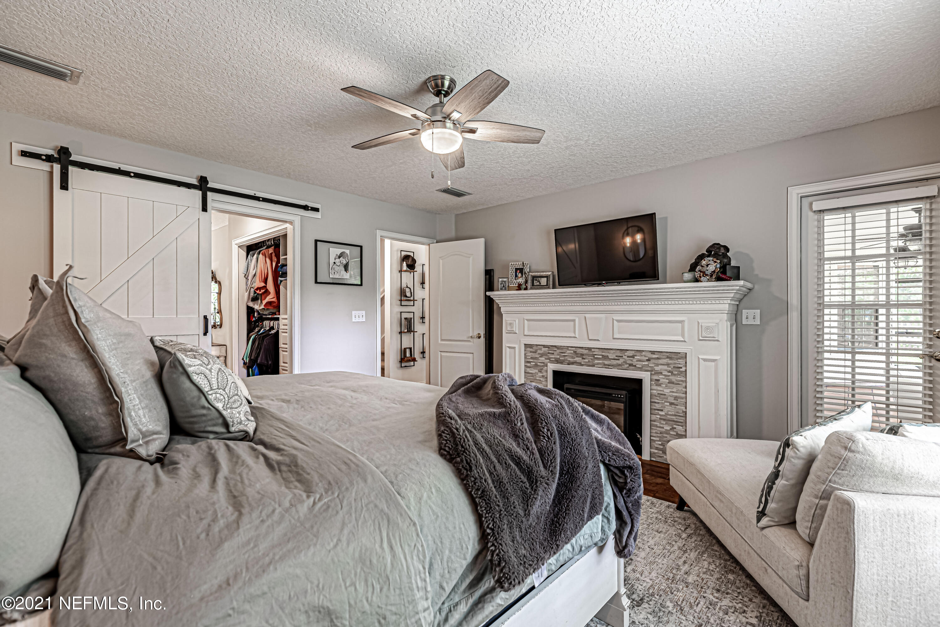 184 Circuit Rider Road Green Cove Springs, FL 32043 - Photo 28 of 58 a bedroom with a bed and a fireplace