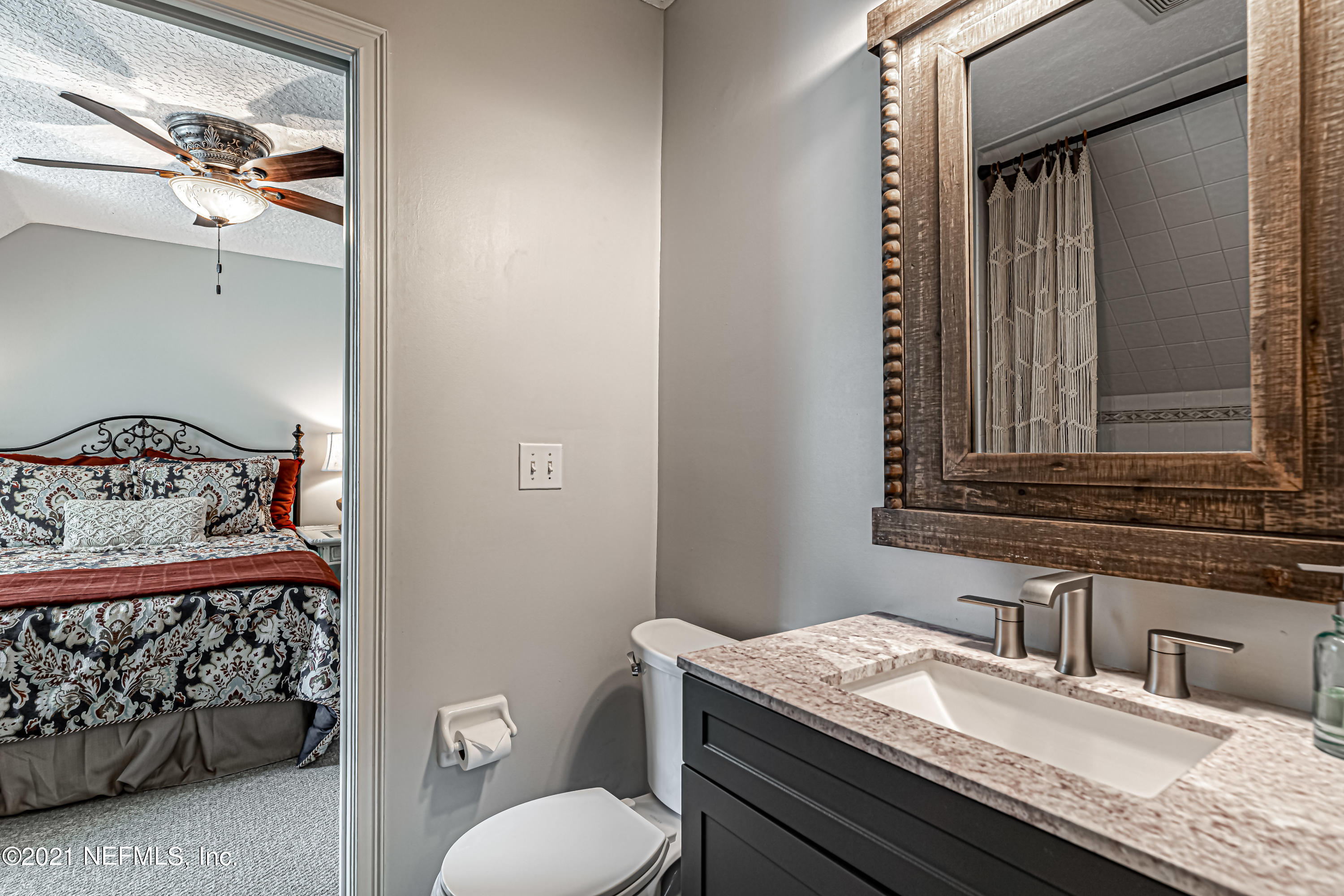 184 Circuit Rider Road Green Cove Springs, FL 32043 - Photo 40 of 58 a bathroom with a granite countertop sink a toilet and mirror