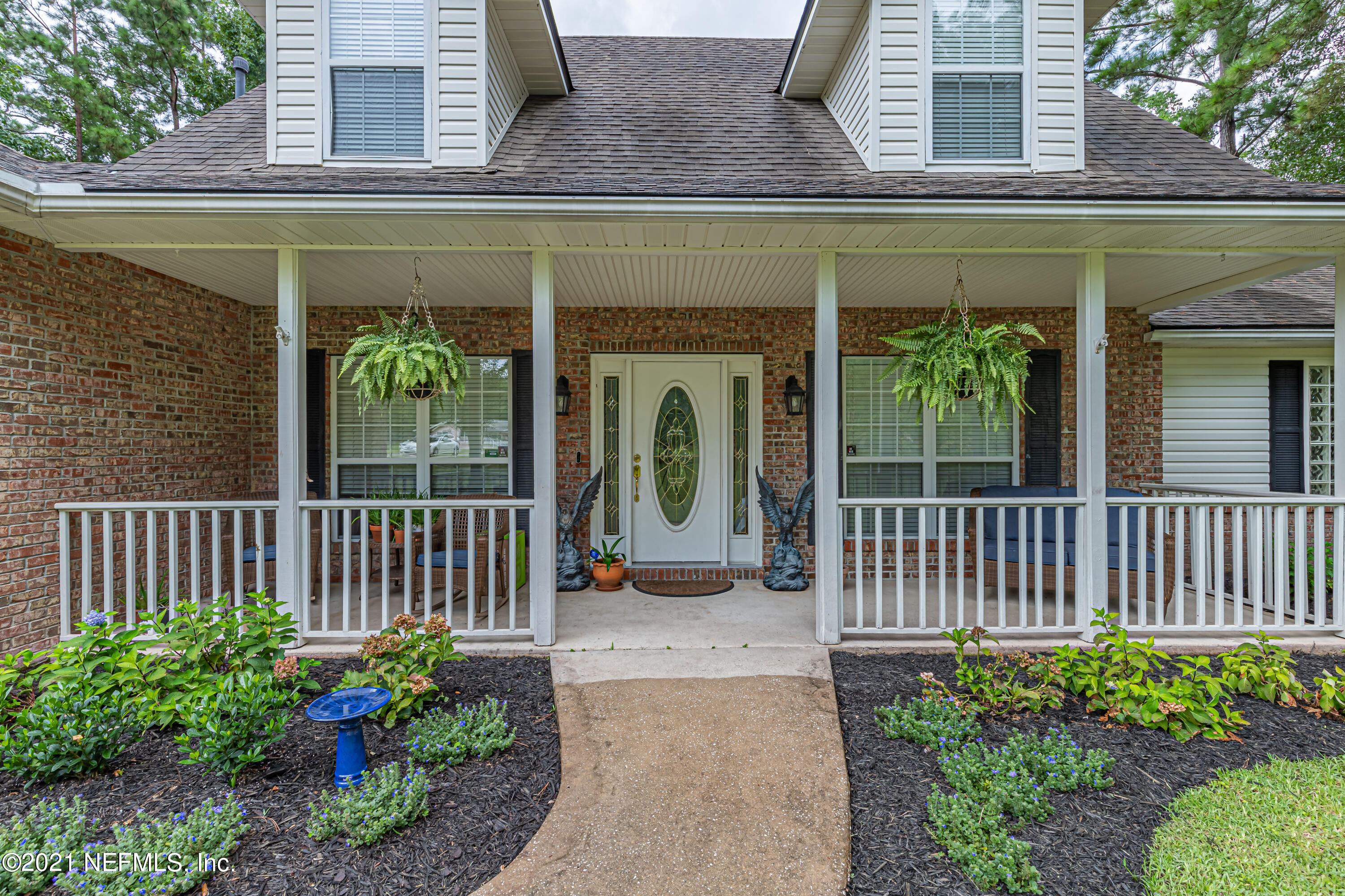 184 Circuit Rider Road Green Cove Springs, FL 32043 - Photo 4 of 58 a view of a house with porch and garden