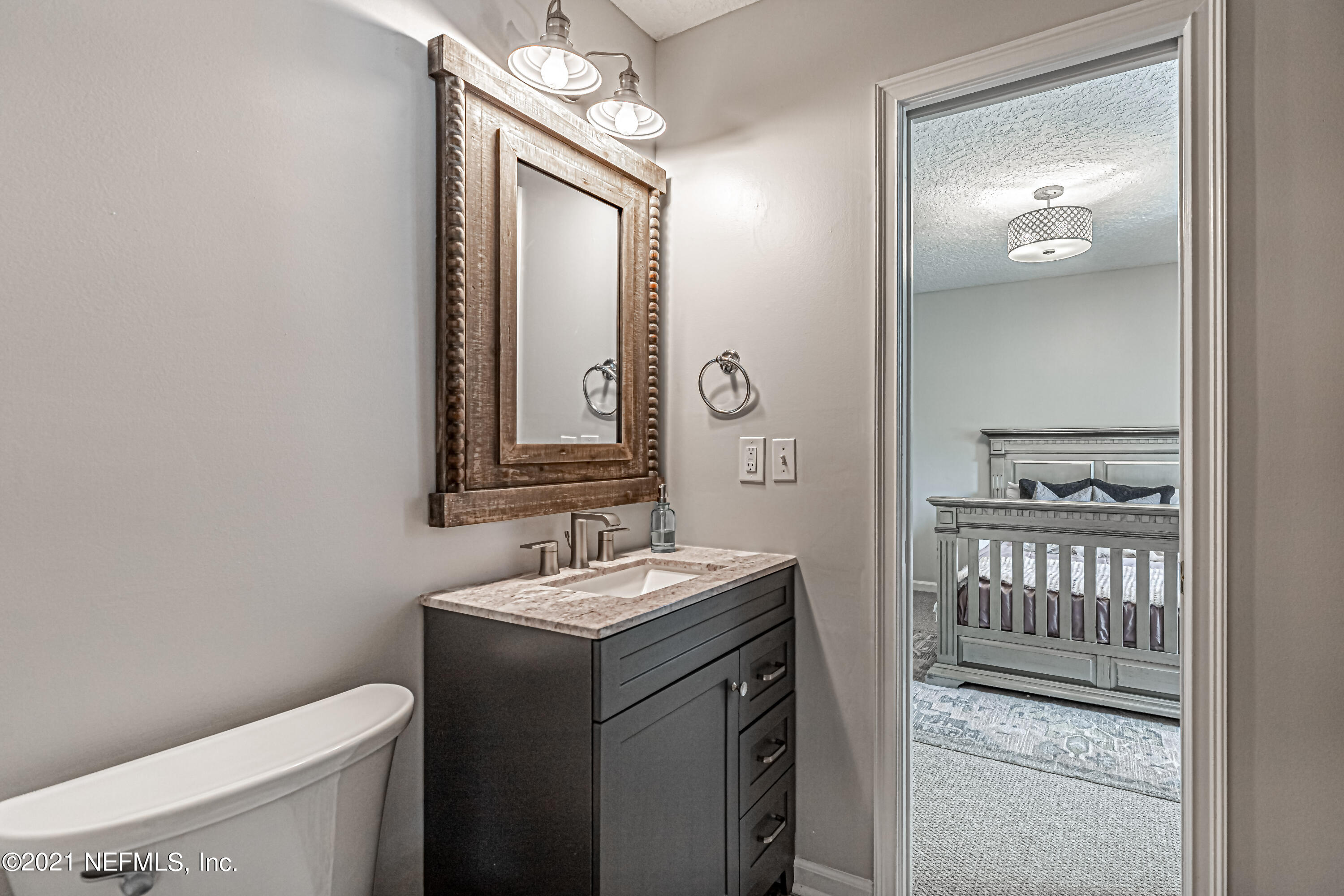 184 Circuit Rider Road Green Cove Springs, FL 32043 - Photo 41 of 58 a bathroom with a sink a toilet and a mirror