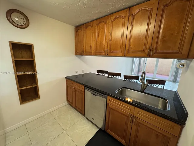 a kitchen with a sink and a refrigerator
