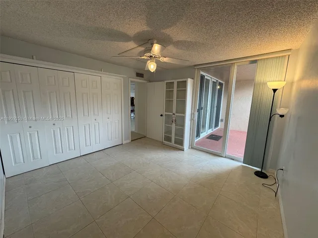 a bathroom with a granite countertop sink toilet and a mirror